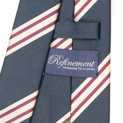 Close-up of the Refinement repp stripe neck tie showing the textured silk weave and brand label detail.