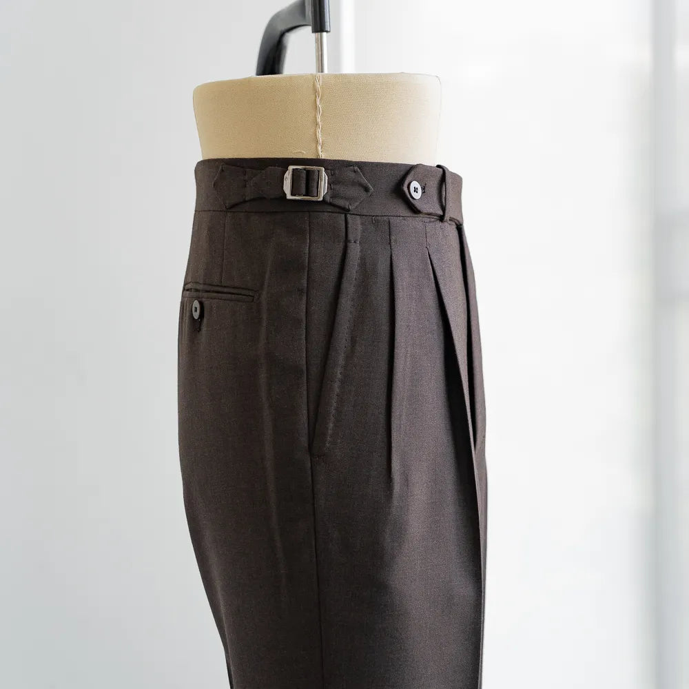 Close-up of the extended waistband tab, button, stitching, and textured Crispaire weave.