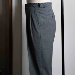 Side view showing the leg profile, side seam, and fluid movement of the sartorial wool fabric.