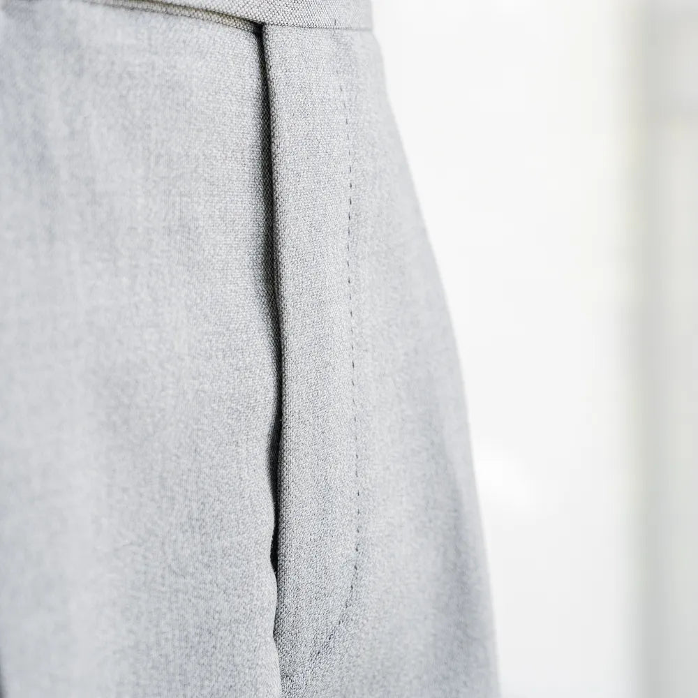 Close-up of the front pleat or flat-front structure showing clean tailoring lines.