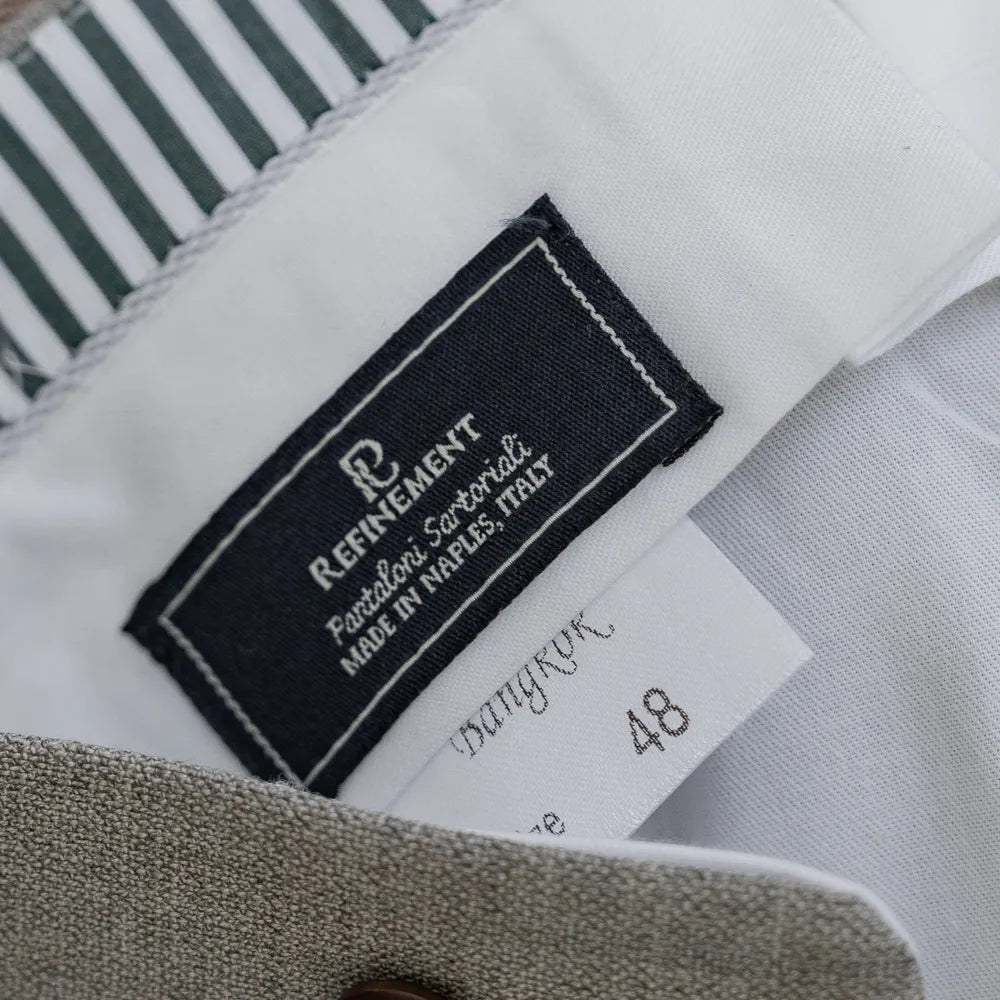 Close-up of the interior Refinement x Drapers label on the Pantaloni Sartoriali New Oatmeal trousers, showing branding, woven detailing, and clean internal finishing.
