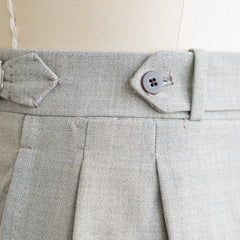 Close-up of the front pleat or flat-front construction showing crisp structure and refined tailoring.