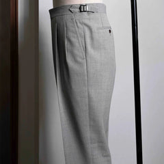 Side view showing the leg line, side seam, and natural movement of the light oatmeal wool fabric.