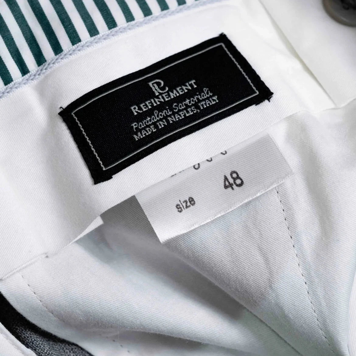 Close-up of the interior label showing Refinement branding and Drapers cloth identification.