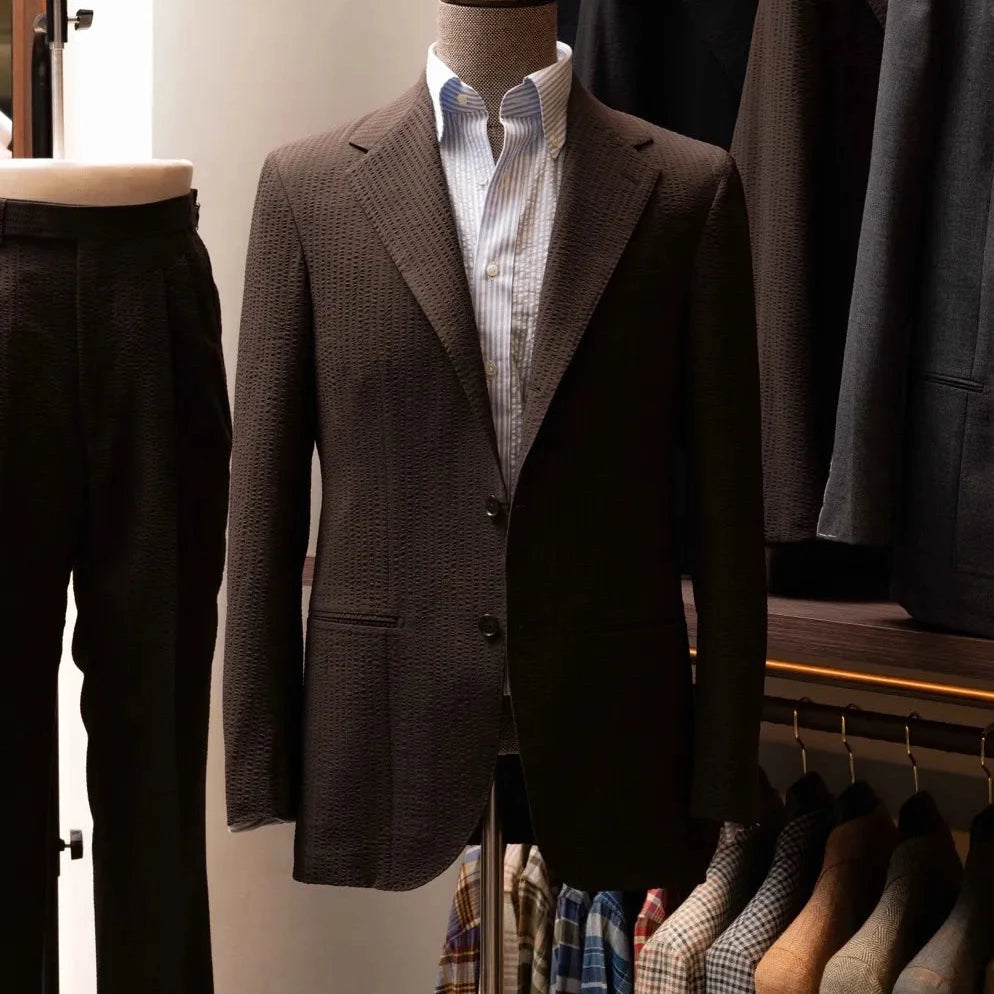 Front view of the Refinement Tailoring Rfmt-01 Suit Jacket Seersucker Dark Brown by Fratelli Tallia di Delfino showing the lightweight single-breasted silhouette and textured dark brown seersucker fabric.