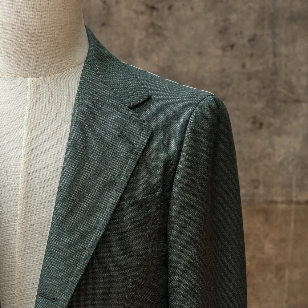 Close-up of the lapel on the RMJ-03 Jacket Green by VBC highlighting the lapel roll, canvas structure, and clean hand-finished edges.