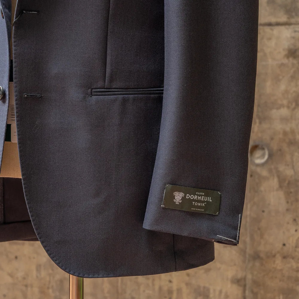 Close-up of the sleeve and hem area of the RMJ-03 Navy Jacket by Dormeuil showing buttonwork, stitching, and finishing.