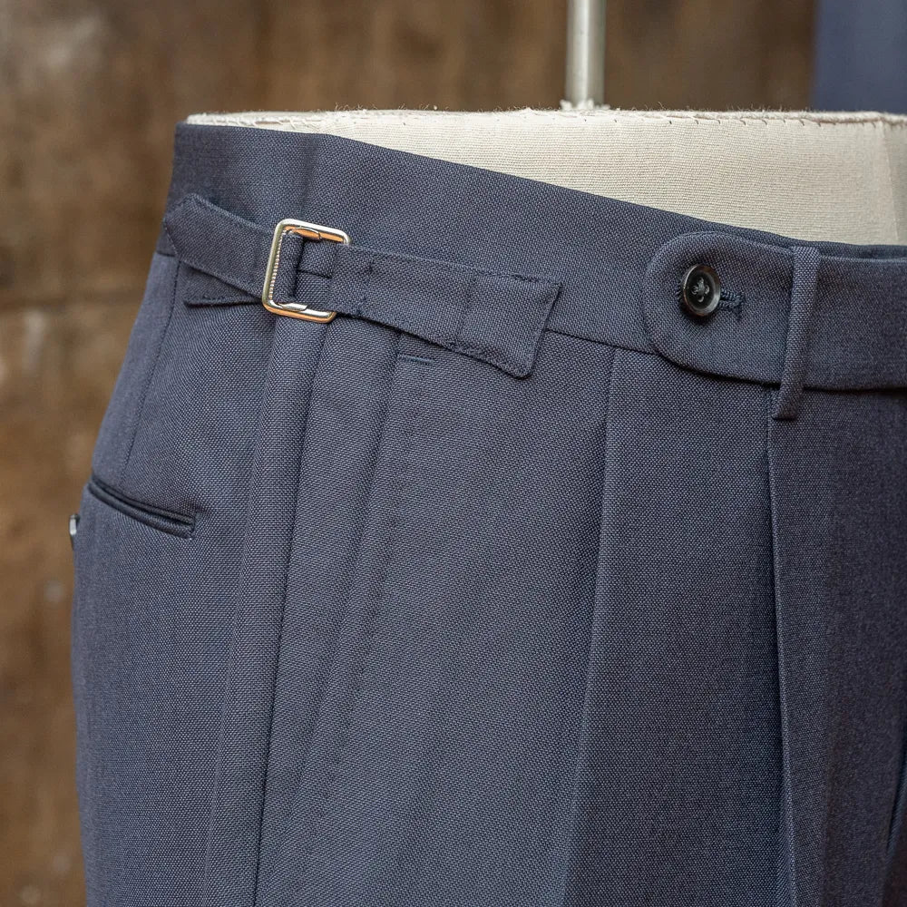 Close-up of the waistband and side adjuster on the RMJ-03 Navy Suit trousers showing the buckle hardware and stitching.