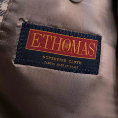 Close-up of the interior label showing Refinement Tailoring branding and E. Thomas cloth identification.