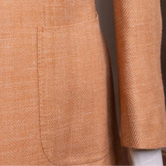 Close-up of the front pocket showing flap design, stitching accuracy, and aligned herringbone pattern.