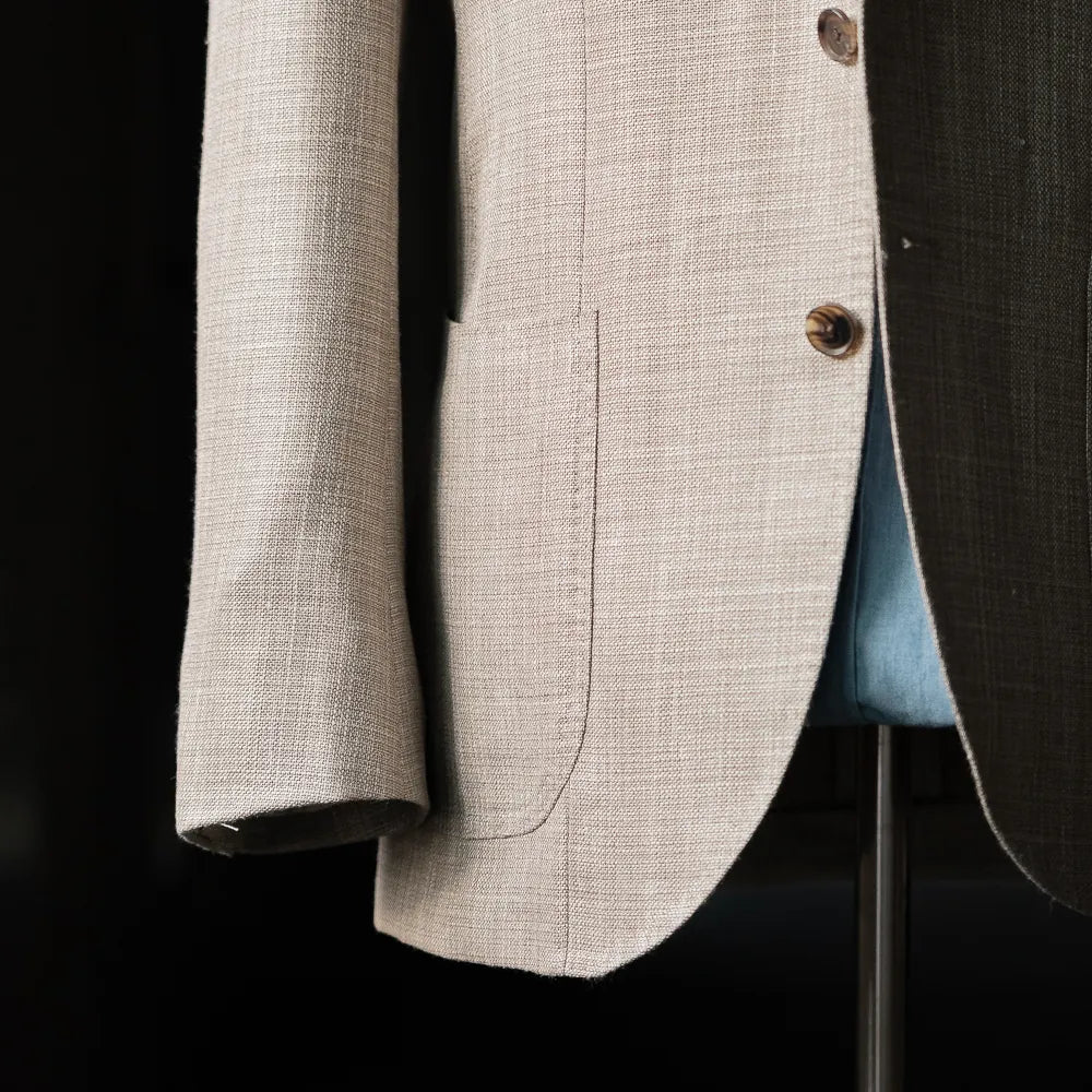 Side view showing the sleeve, button stance, and drape of the Loro Piana Summertime beige fabric.