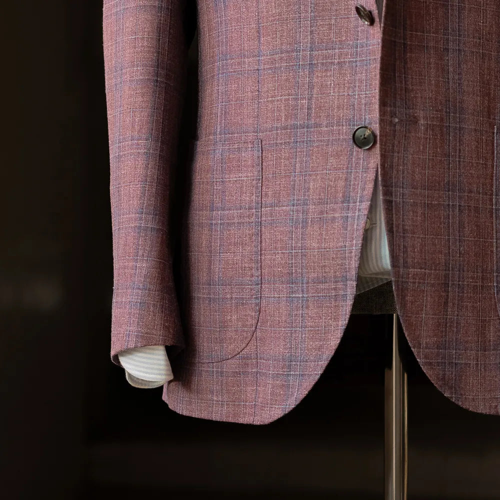 Side and sleeve detail of the Rfmt-01 jacket showing button stance, sleeve finishing, and the subtle checked pattern in Loro Piana Summertime cloth.