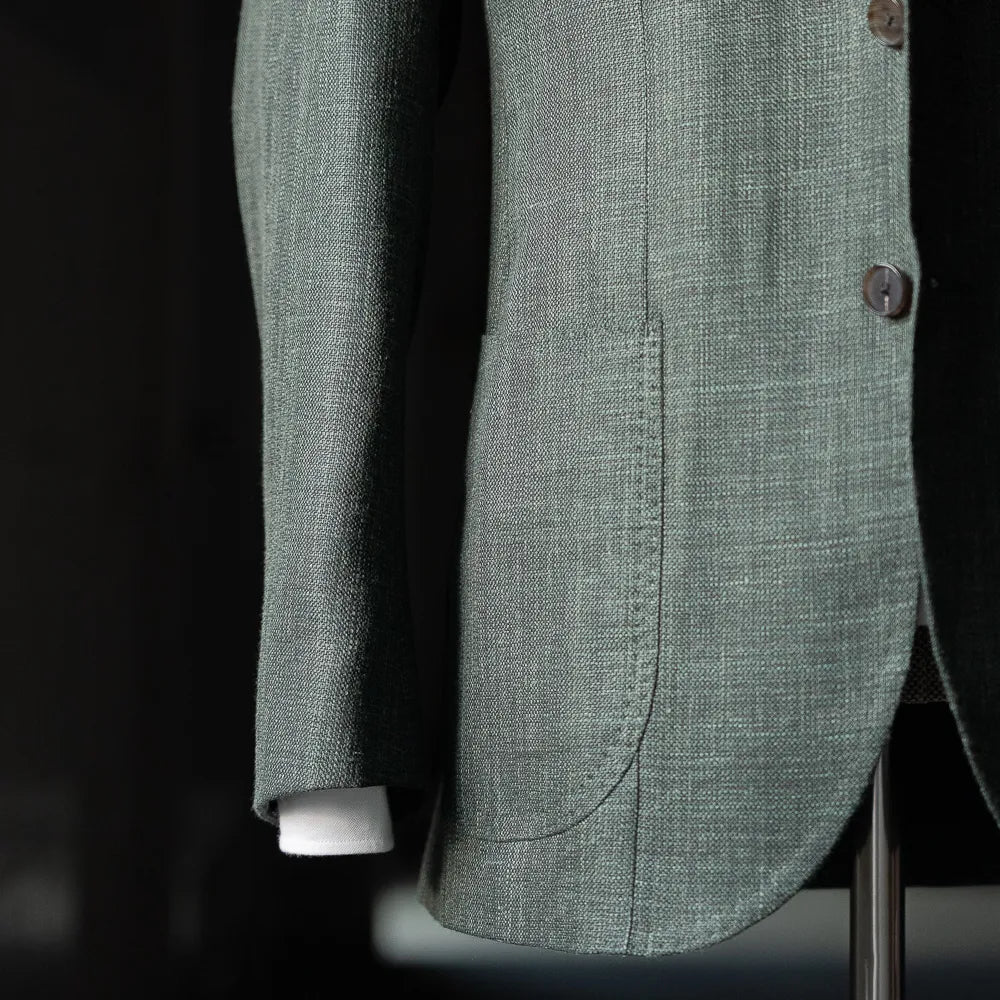 Side view showing the sleeve construction, button stance, and breathable Loro Piana Summertime fabric.