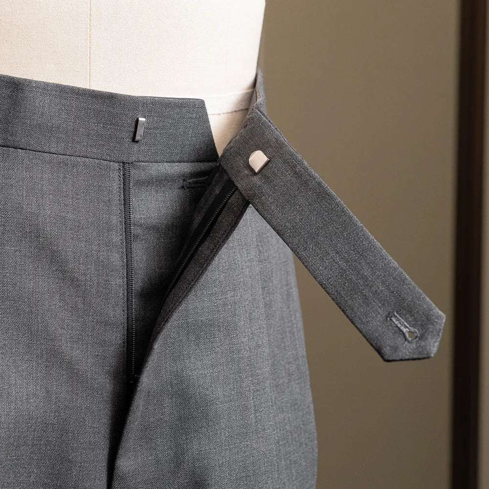 Close-up of the waistband extension and front closure construction.