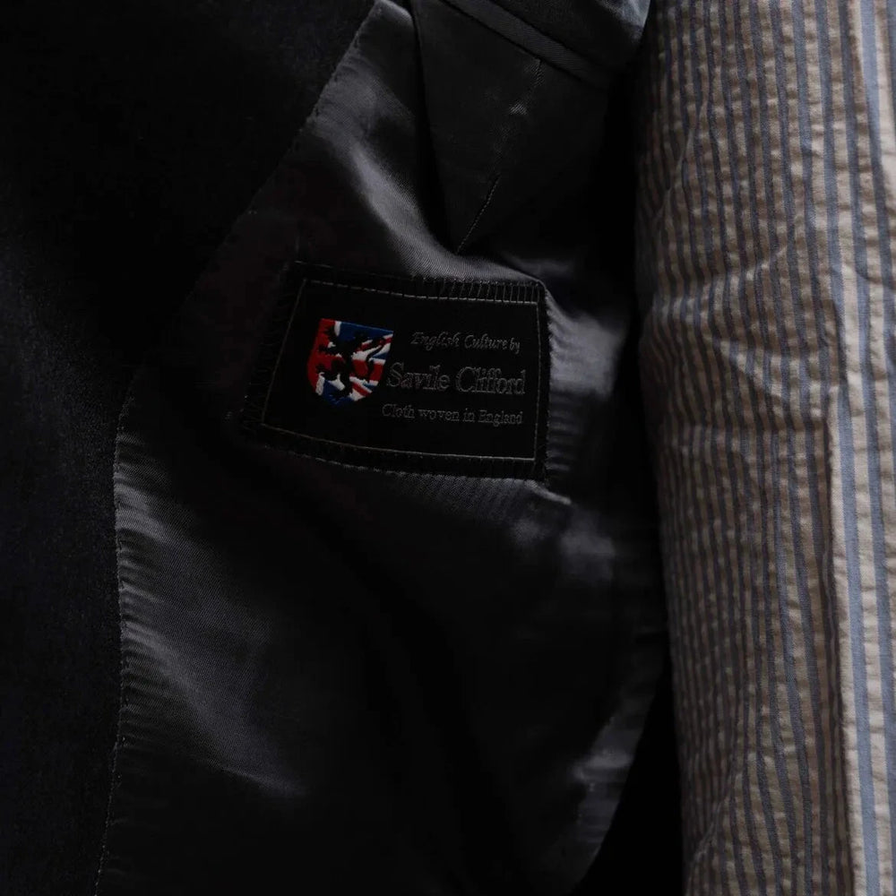 Close-up of the interior label showing Refinement Tailoring branding and Savile Clifford cloth identification.
