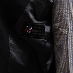 Close-up of the interior label showing Refinement Tailoring branding and Savile Clifford cloth identification.