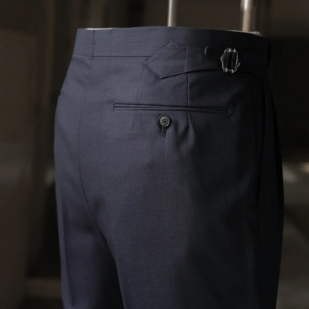 Close-up of the trouser back showing the side adjuster, pocket shape, and wool texture.