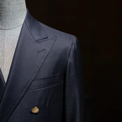 Close-up of the lapel roll and chest pocket showing clean tailoring lines.
