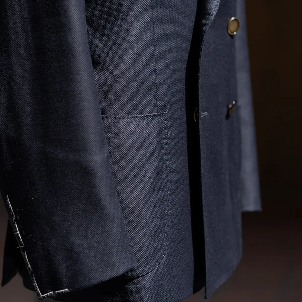 Upper front view highlighting the peak lapel shape and chest pocket detail.