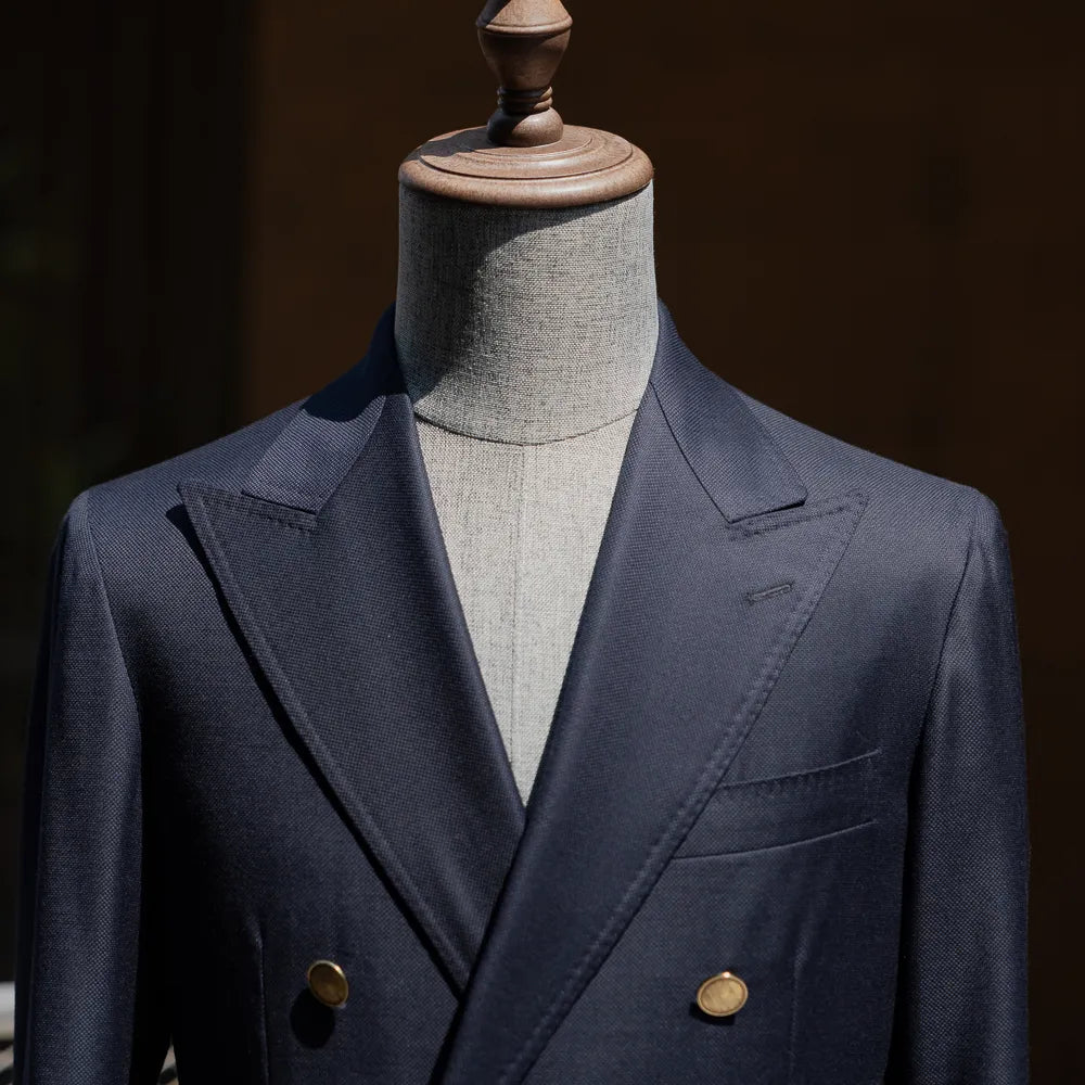Upper front view highlighting the peak lapel shape and chest pocket detail.