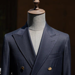 Upper front view highlighting the peak lapel shape and chest pocket detail.