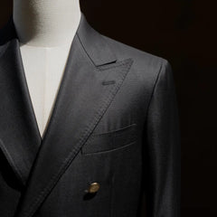 Close-up of the lapel roll and chest pocket showing refined tailoring lines.
