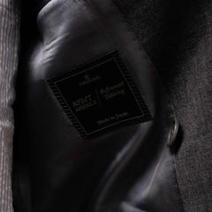 Close-up of the interior label showing Refinement Tailoring branding and Woodhead cloth identification.