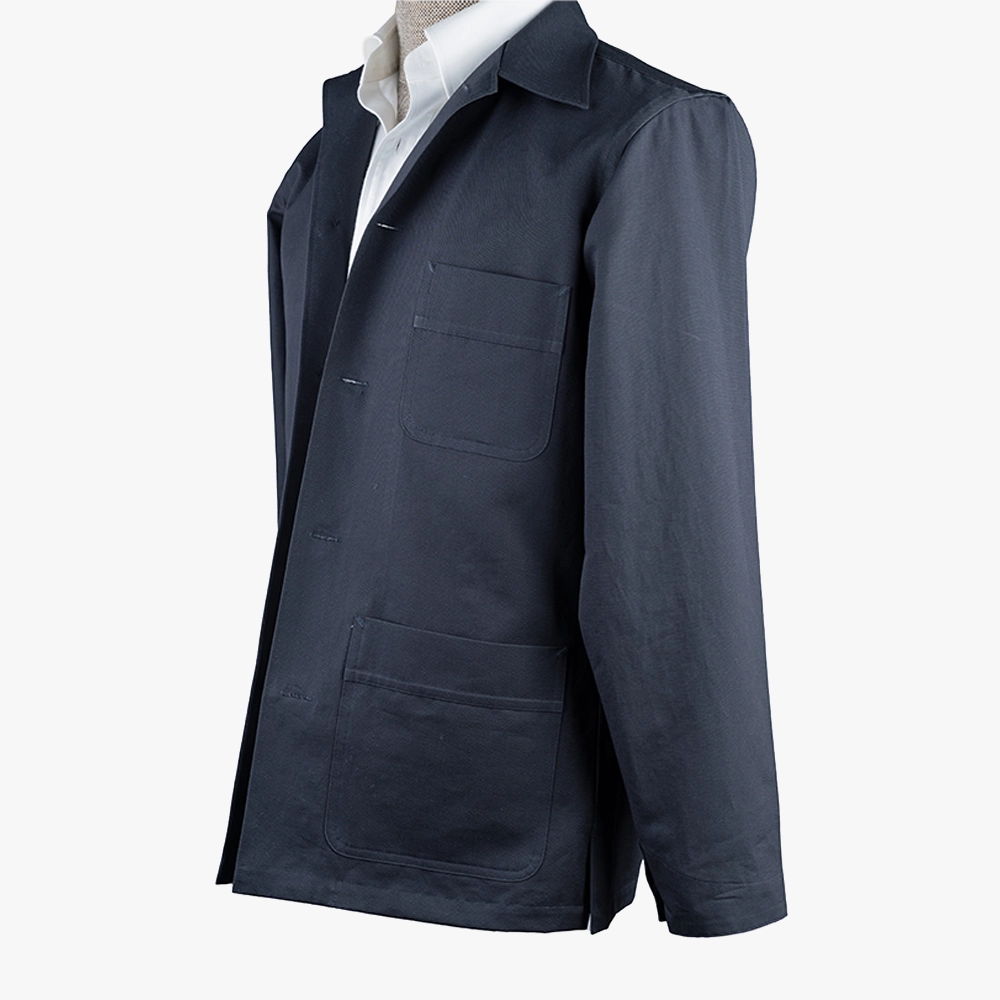 Side view showing the sleeve line, side seam, and natural drape of the navy fabric.