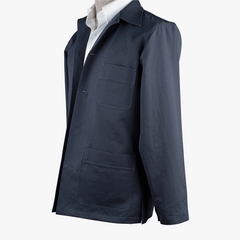 Side view showing the sleeve line, side seam, and natural drape of the navy fabric.