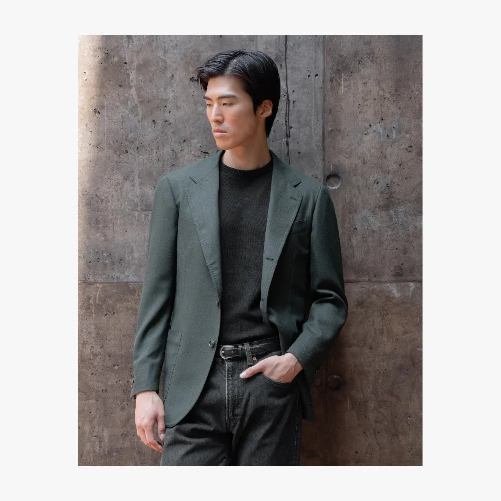 Man wearing RMJ-03 green single breasted jacket by Ring Jacket, styled in a refined smart casual look