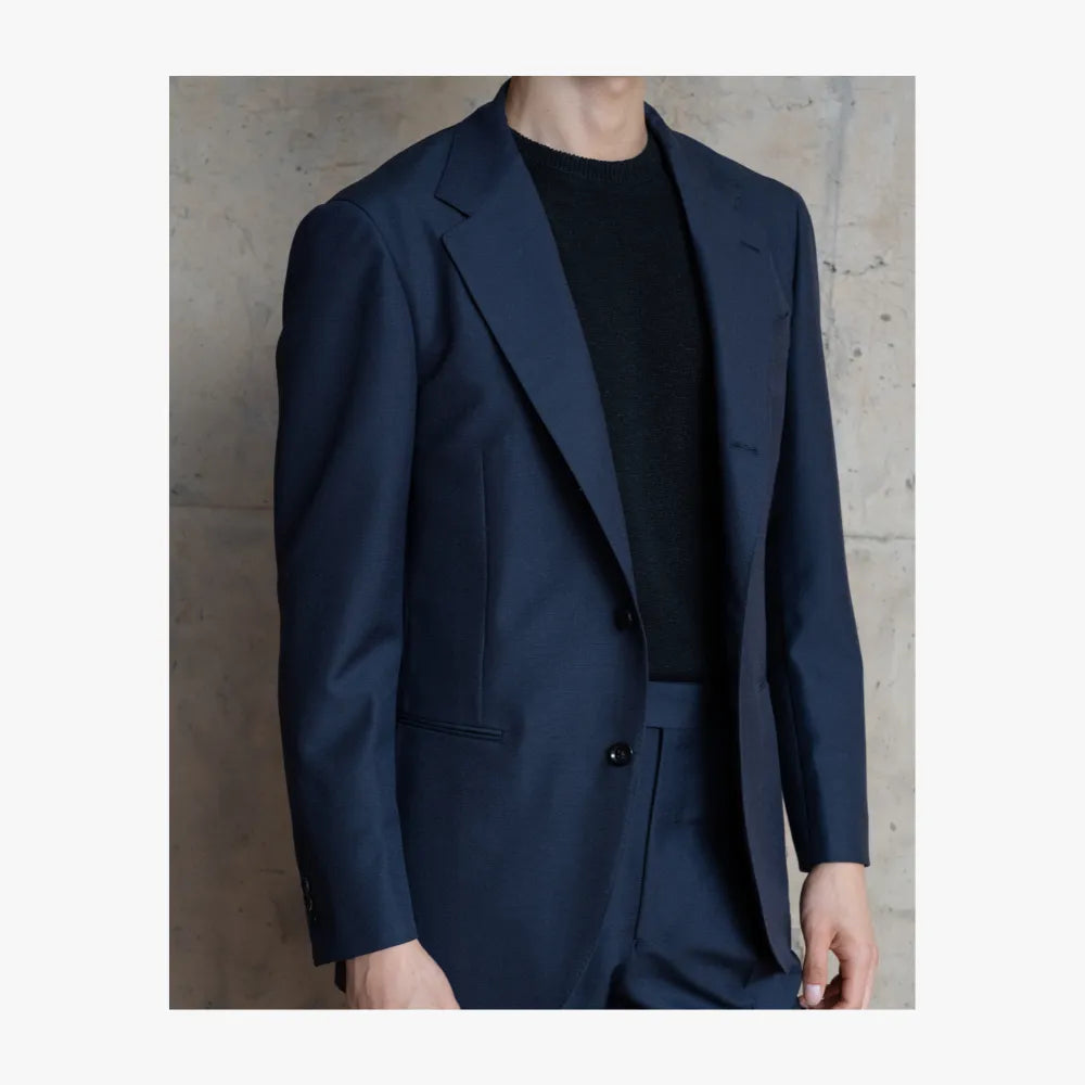 Close-up detail of RMJ-03 navy single breasted suit by Ring Jacket showing Doemueil fabric texture