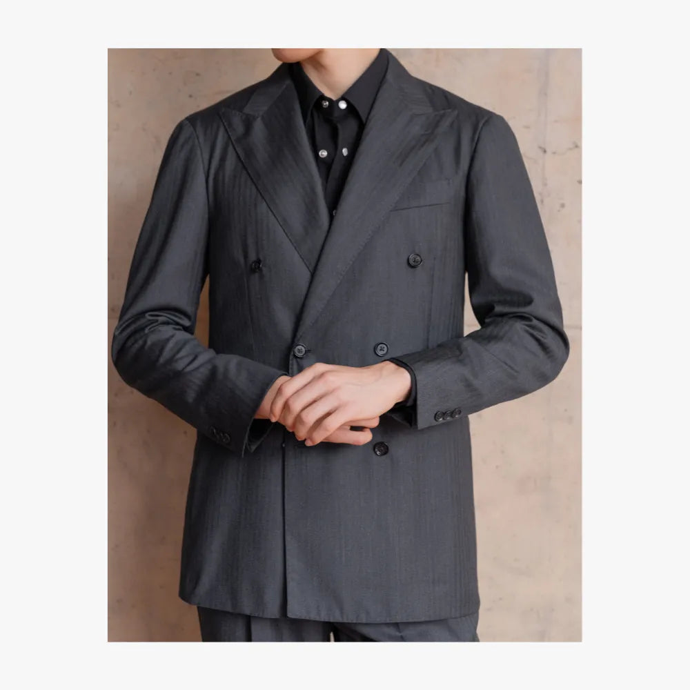 Close-up detail of RMJ-04 charcoal grey double-breasted suit by Ring Jacket showing VBC herringbone texture