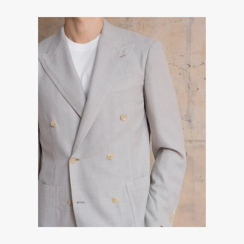 Close-up detail of RMJ-04 ivory double breasted jacket by Ring Jacket showing VBC hopsack texture