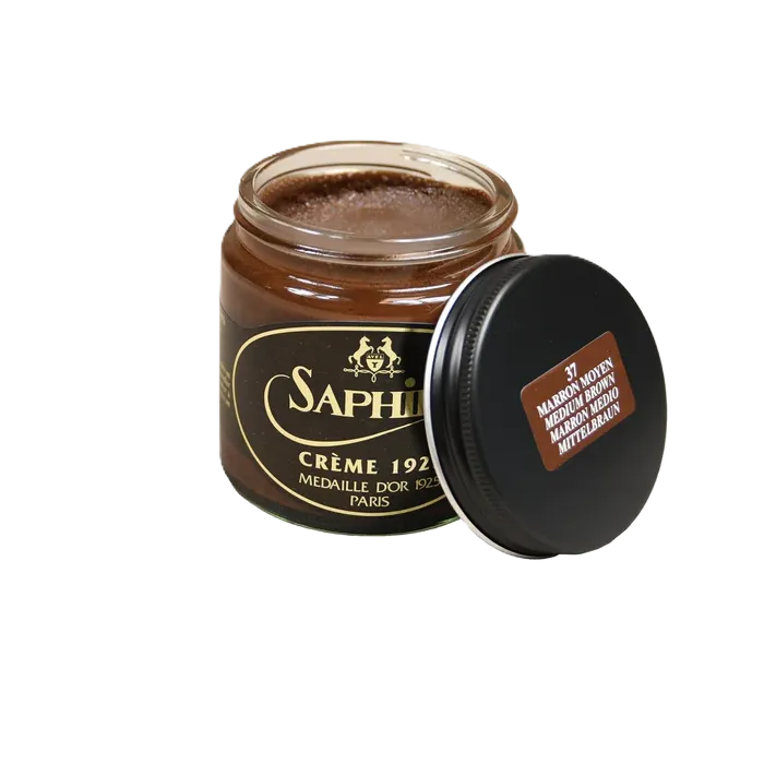 Front view of Saphir Creme 1925 in Medium Brown, featuring the glass jar and mid-brown cream tone designed for conditioning and color restoration.