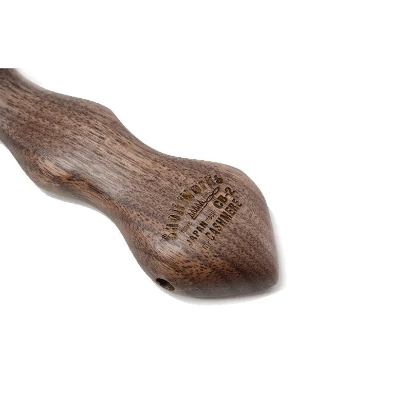 Close-up of the Shoji Horsehair Clothes Brush handle showing the wood grain and ergonomic shaping.