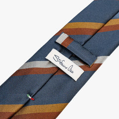 Close-up of the back side of the Stefano Cau regimental tie showing the brand label, hand-finished stitching, and clean construction.