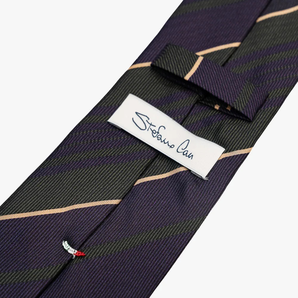 Close-up of the back side of the Stefano Cau regimental tie showing the brand label, hand-finished stitching, and clean construction.