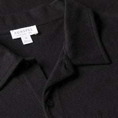 Close-up of the collar of the Sunspel Riviera Polo Shirt Black showing the breathable mesh cotton and refined neckline.