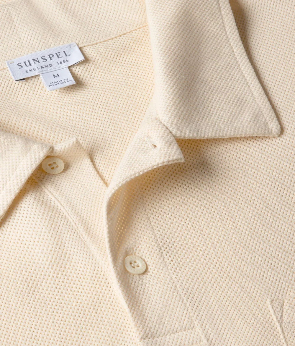 Close-up of the collar of the Sunspel Riviera Polo Shirt Buttermilk showing the breathable mesh cotton and refined neckline.