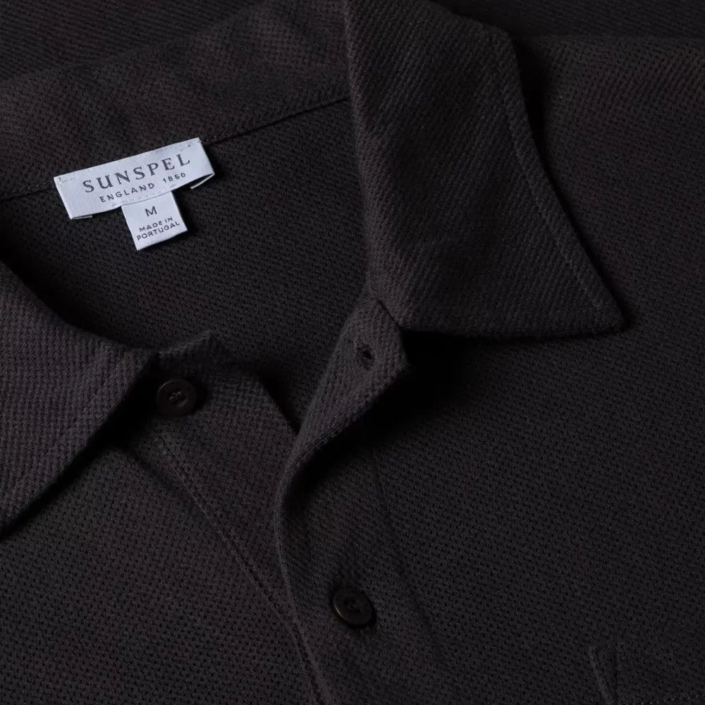 Close-up of the collar of the Sunspel Riviera Polo Shirt Charcoal showing the breathable mesh cotton and refined neckline.