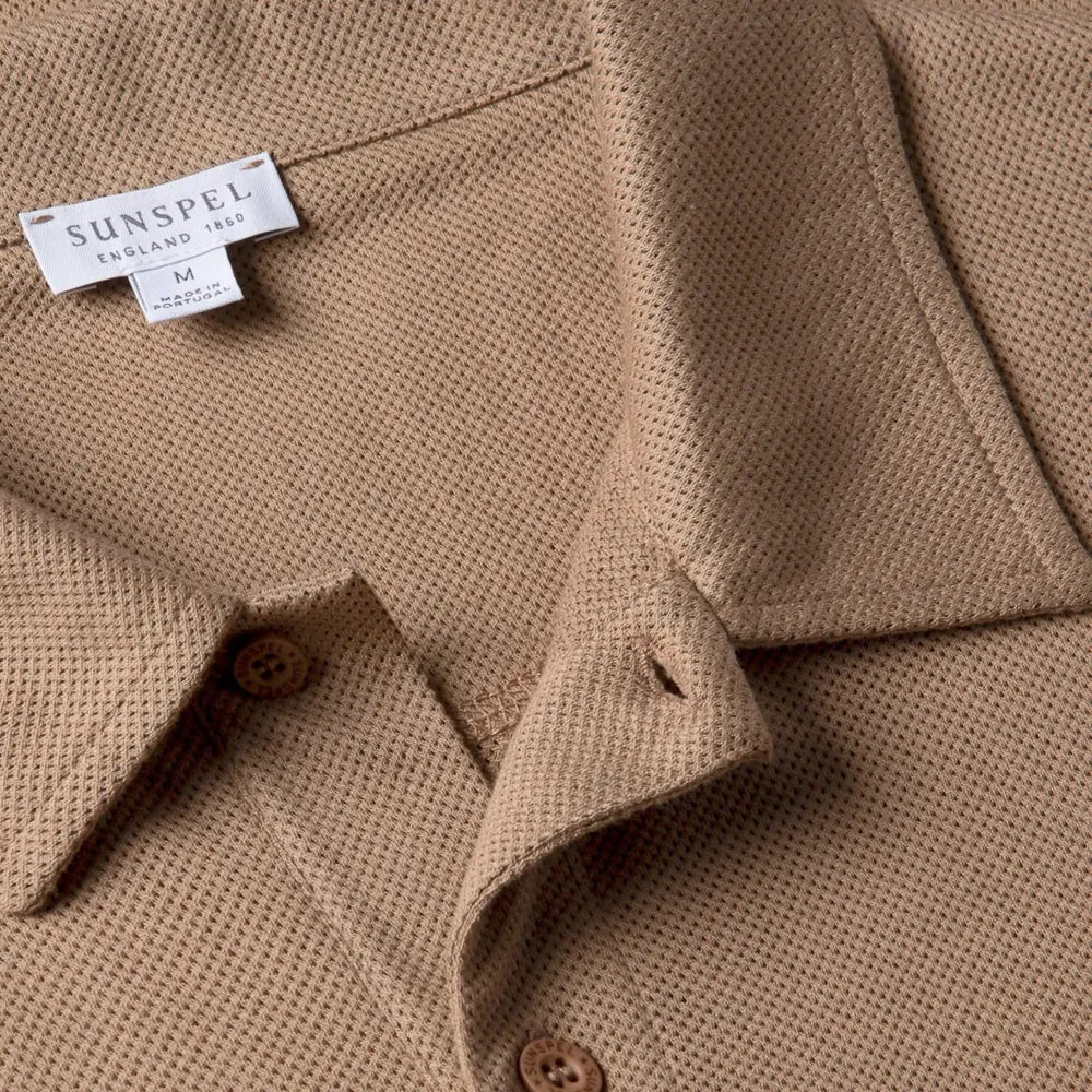 Close-up of the collar of the Sunspel Riviera Polo Shirt Dune showing the breathable mesh cotton and refined neckline.