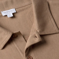 Close-up of the collar of the Sunspel Riviera Polo Shirt Dune showing the breathable mesh cotton and refined neckline.