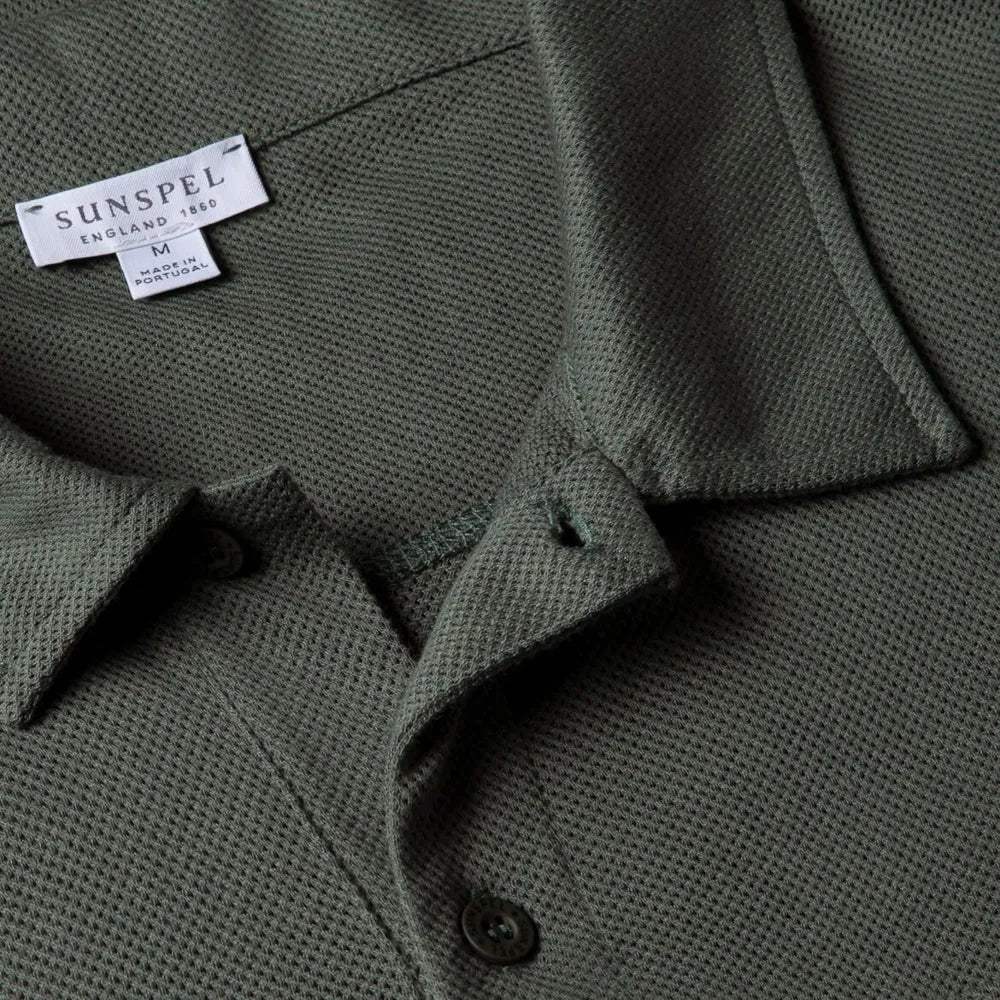 Close-up of the collar of the Sunspel Riviera Polo Shirt Dusk Green showing the breathable mesh cotton and refined neckline.