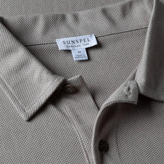 Close-up of the collar of the Sunspel Riviera Polo Shirt Mid Grey showing the breathable mesh cotton and refined neckline.
