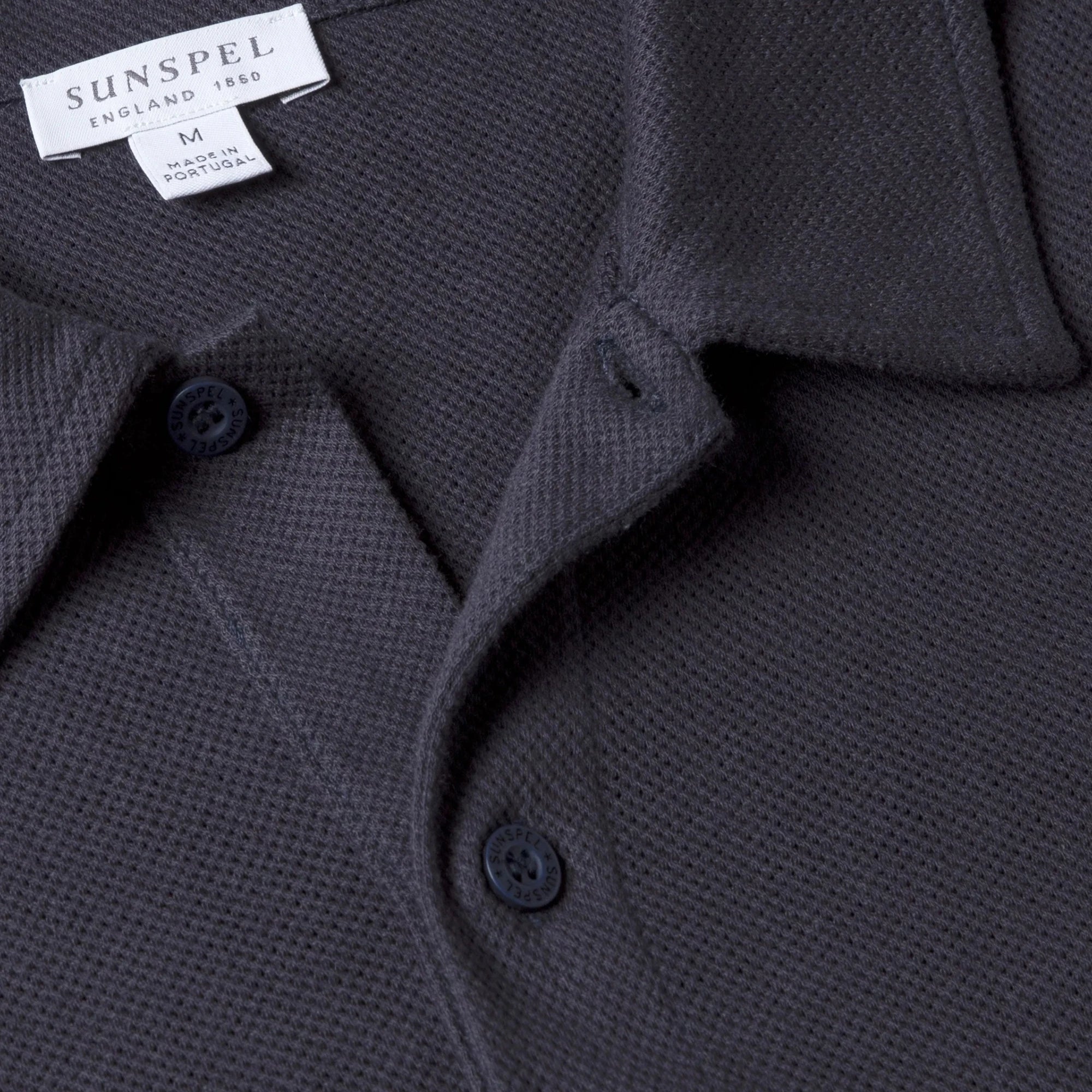 Close-up of the polo collar highlighting the structured collar and button placket detail.