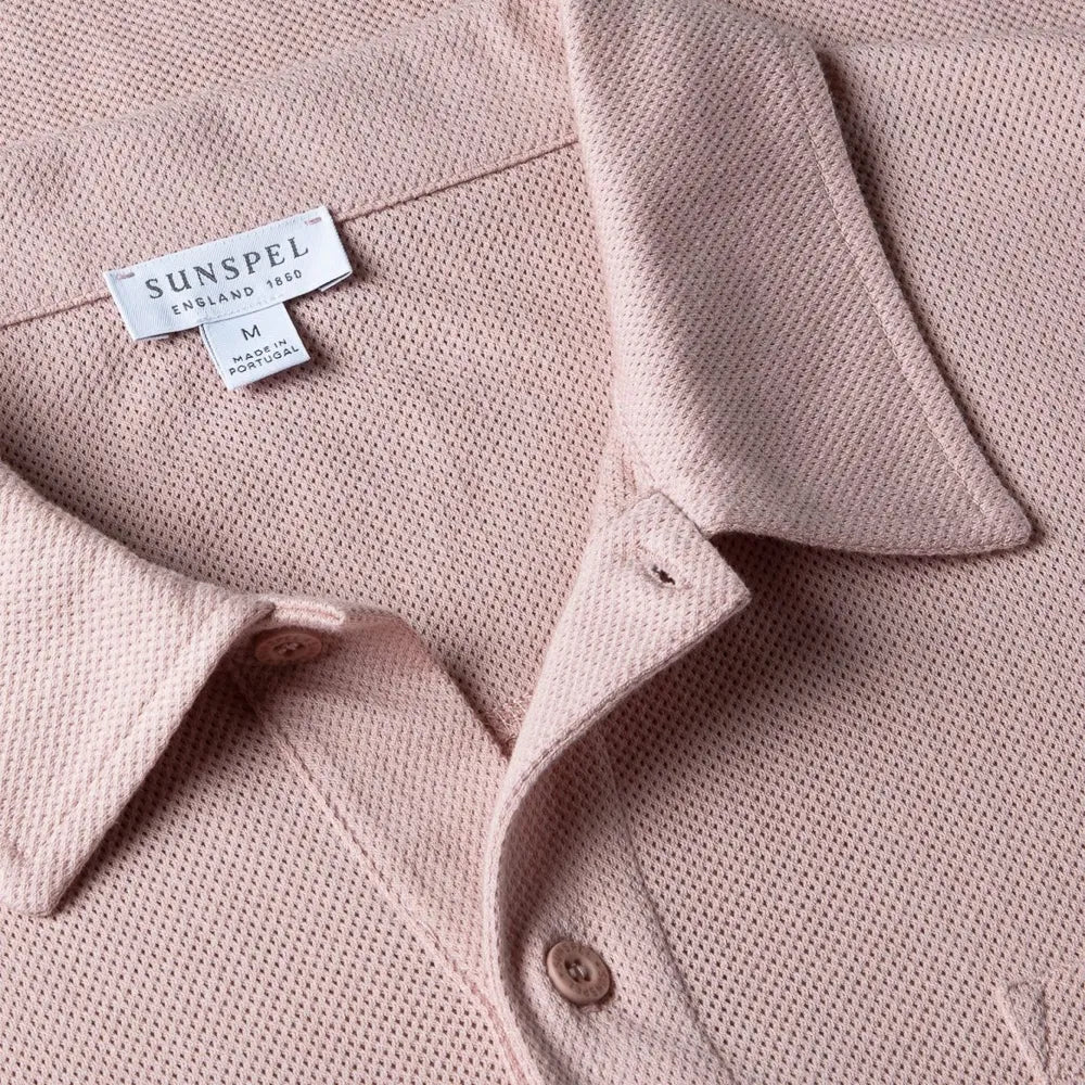 Close-up of the collar of the Sunspel Riviera Polo Shirt Pale Pink showing the breathable mesh cotton and refined neckline.