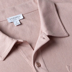 Close-up of the collar of the Sunspel Riviera Polo Shirt Pale Pink showing the breathable mesh cotton and refined neckline.