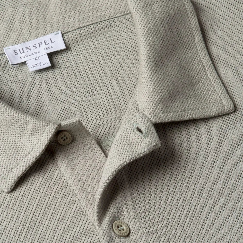 Close-up of the collar of the Sunspel Riviera Polo Shirt Pastel Green showing the breathable mesh cotton and refined neckline.