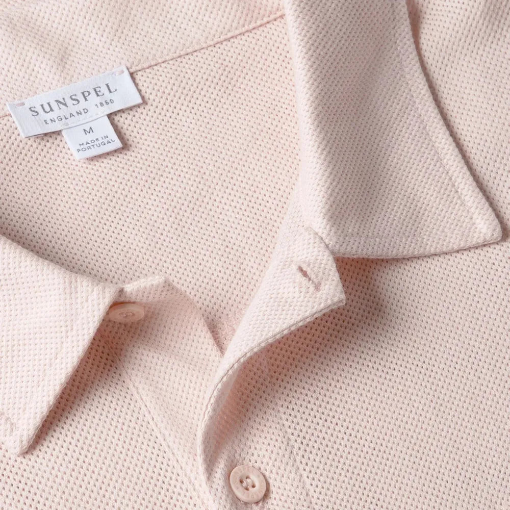 Close-up of the collar of the Sunspel Riviera Polo Shirt Pastel Pink showing the breathable mesh cotton and refined neckline.