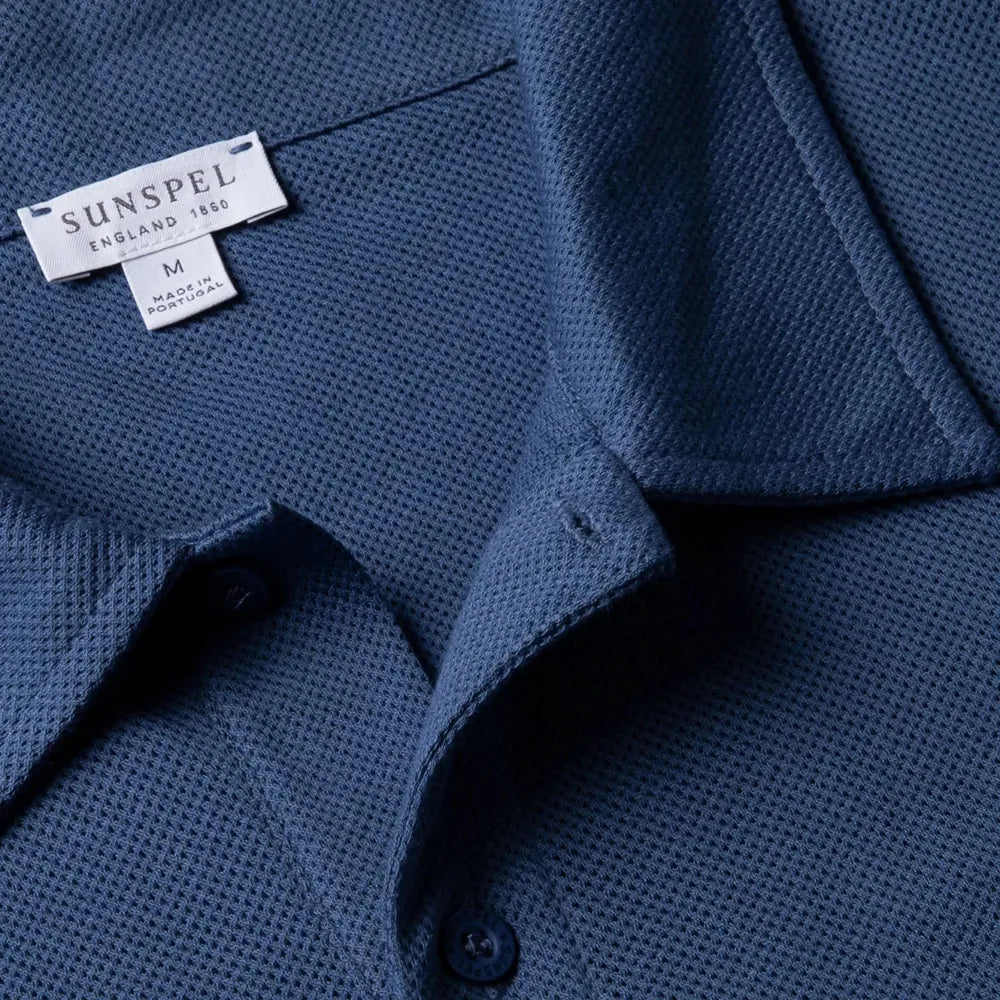 Close-up of the collar of the Sunspel Riviera Polo Shirt Soft Denim showing the breathable mesh cotton and refined neckline.
